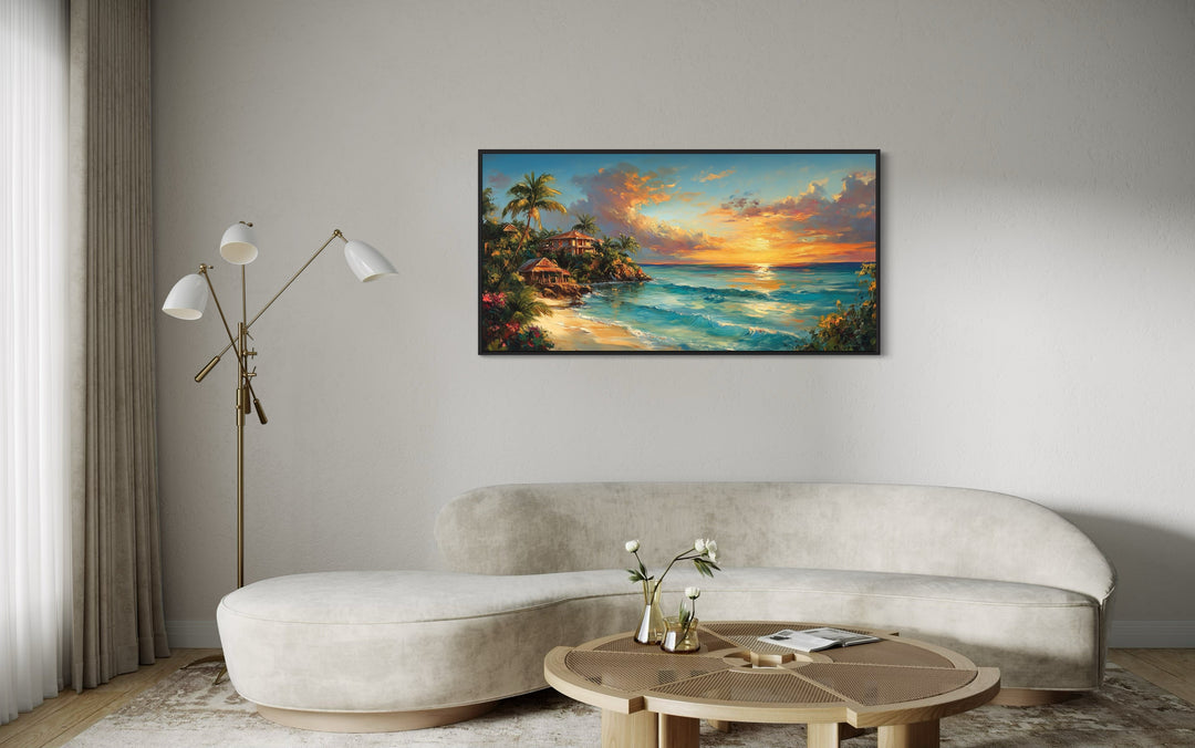 Jamaican Sunset Beach Framed Canvas Wall Art hanging above a modern curved sofa in a living room.