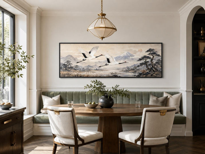Japanese watercolor canvas of red-crowned cranes over misty mountains in a dining nook.