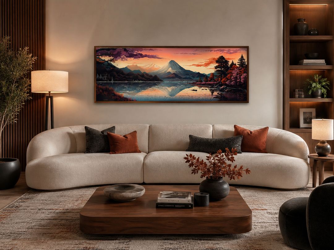 Horizontal framed canvas of Mt. Fuji and Lake Kawaguchiko landscape above a white curved sofa.