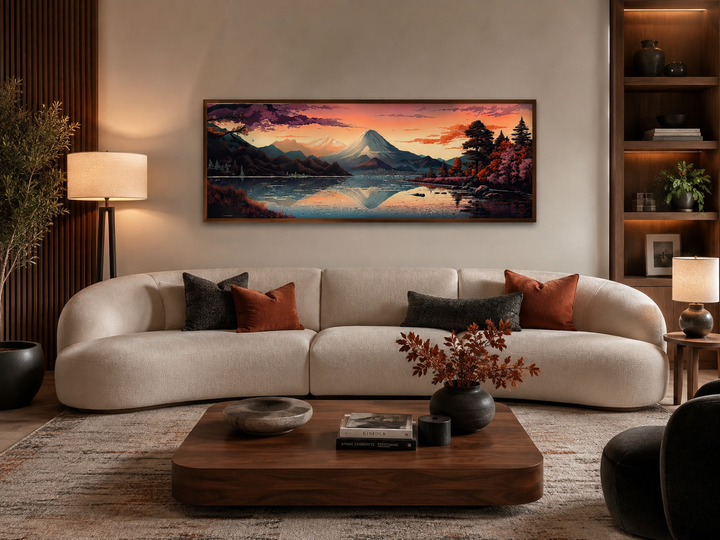 Horizontal framed canvas of Mt. Fuji and Lake Kawaguchiko landscape above a white curved sofa.