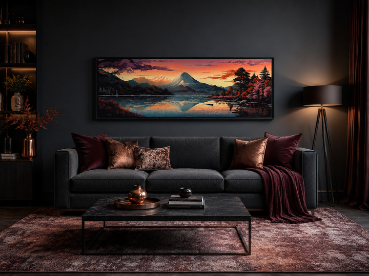 Horizontal framed canvas of Mt. Fuji and Lake Kawaguchiko above a dark sofa in a modern room.