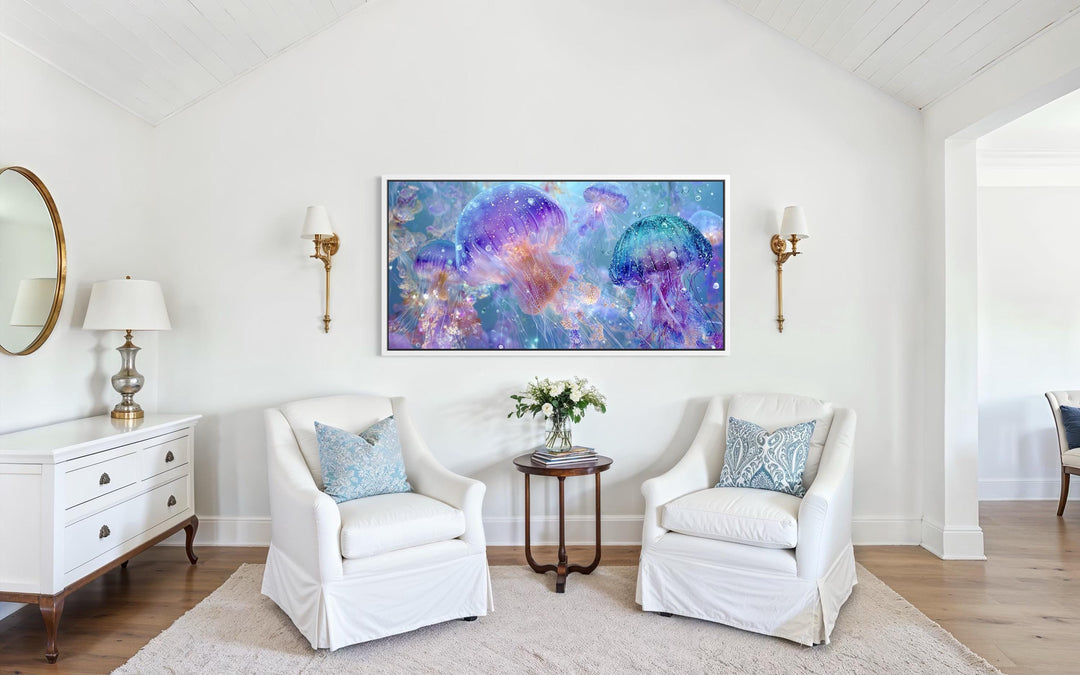 A horizontal canvas print of colorful purple and blue jellyfish hangs in a bright, coastal room.