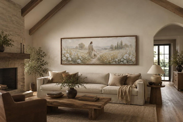 Jesus and lamb in a wildflower field canvas wall art above a sofa in a farmhouse living room.