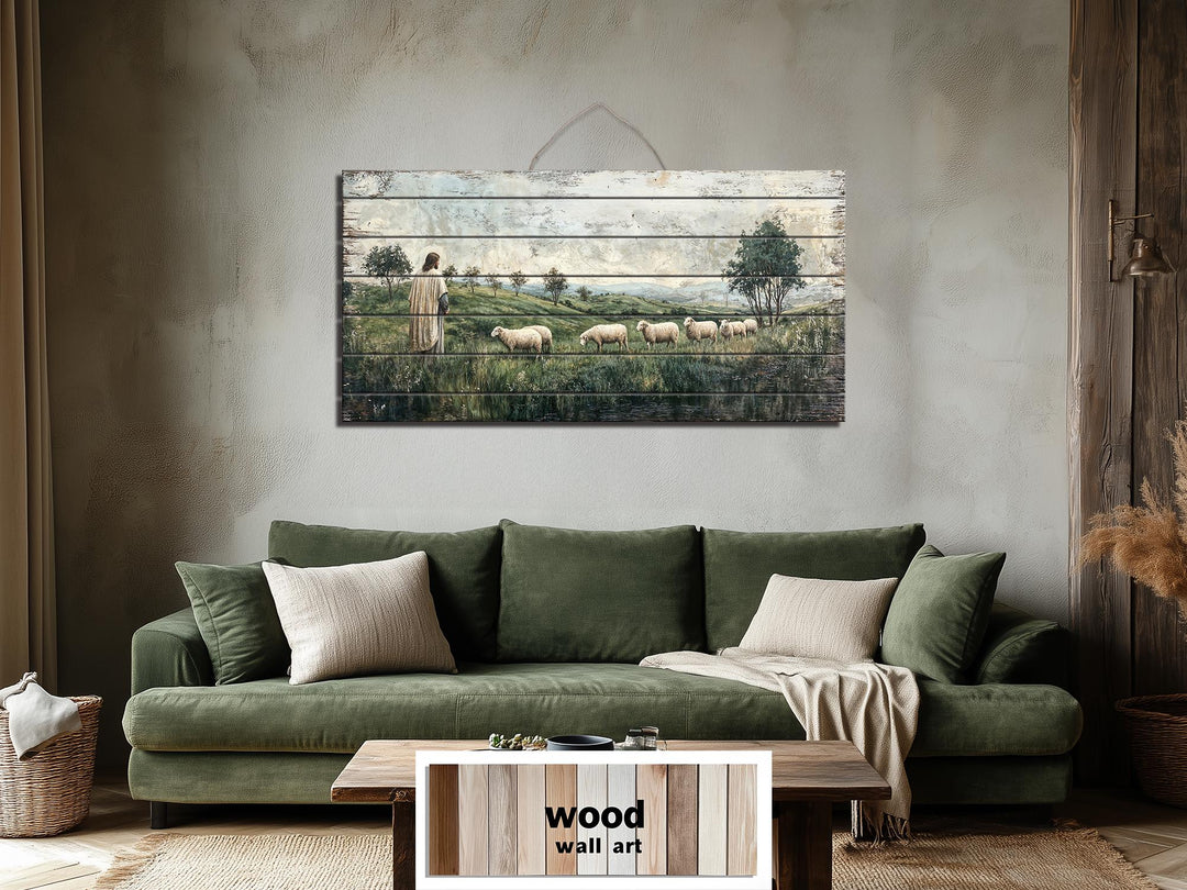 Jesus and sheep distressed wood wall art hanging above a green sofa in a rustic living room.