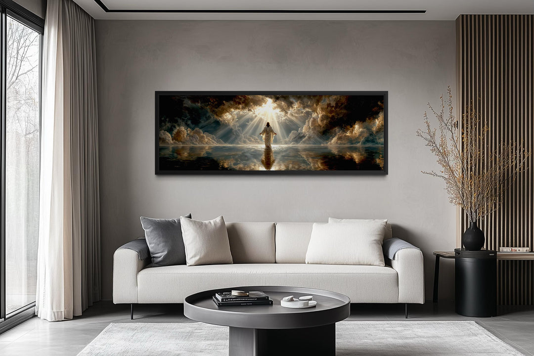 Panoramic canvas print of Jesus walking on water displayed above a modern sofa in a living room.
