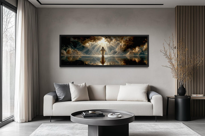 Panoramic canvas print of Jesus walking on water displayed above a modern sofa in a living room.