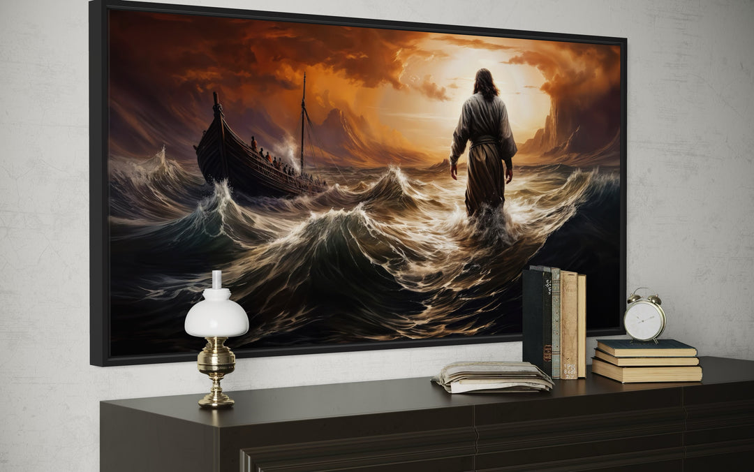 Framed canvas art of Jesus walking on stormy water toward a boat, displayed above a dark dresser.