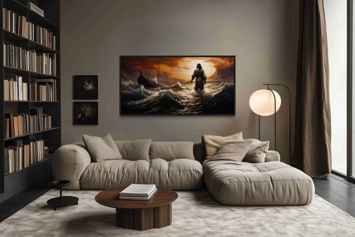 Jesus walking on water in a storm framed canvas wall art above a modern sofa in a living room.