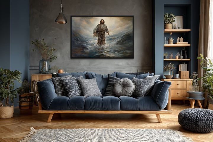 Framed canvas wall art of Jesus walking on water above a blue sofa in a modern living room.