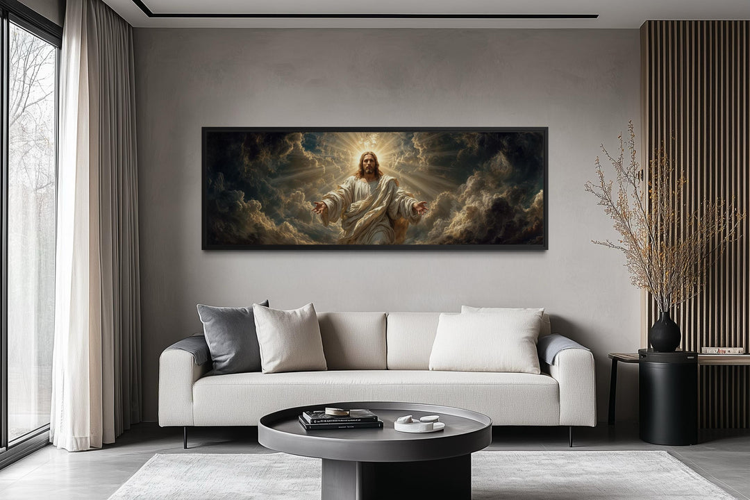Panoramic canvas print of Jesus with open arms in a dramatic sky, hung above a modern sofa.