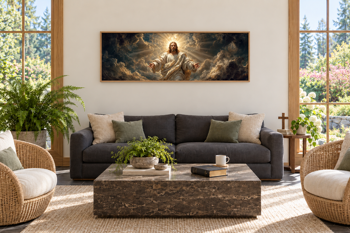 Panoramic Jesus wall art canvas with open arms displayed above a sofa in a bright living room.