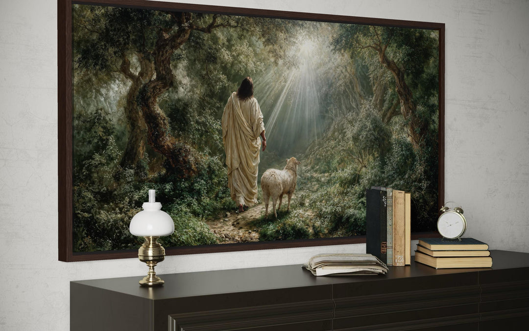 Jesus the Good Shepherd canvas wall art depicting Christ and a lamb in a sunlit forest.