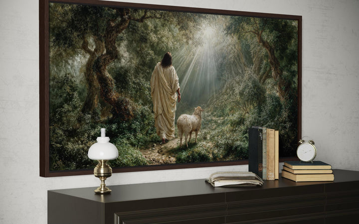 Jesus the Good Shepherd canvas wall art depicting Christ and a lamb in a sunlit forest.