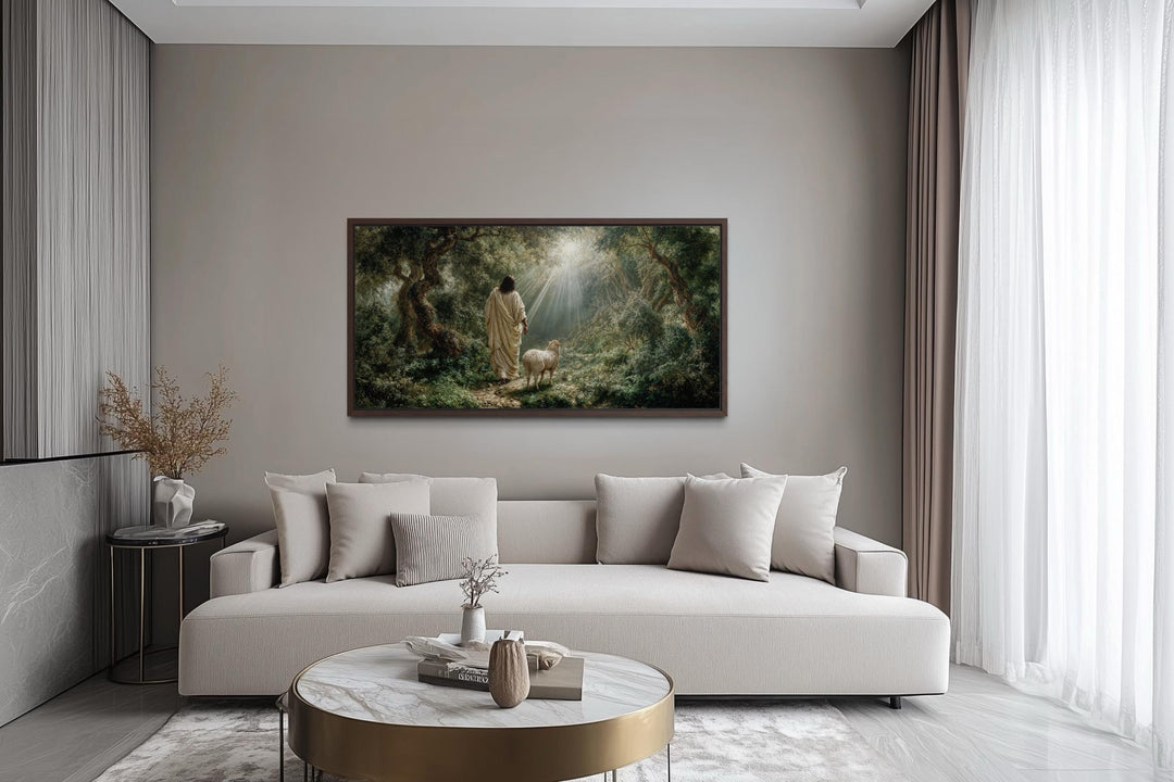 Jesus the Good Shepherd and lamb in the forest canvas wall art displayed in a modern living room.