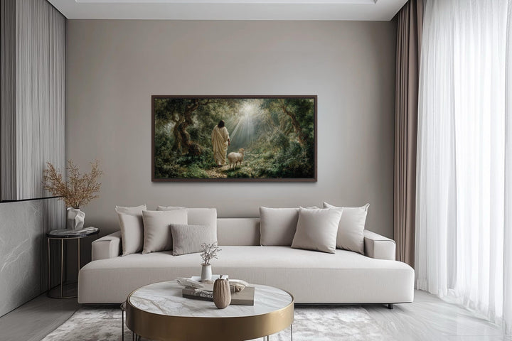 Jesus the Good Shepherd and lamb in the forest canvas wall art displayed in a modern living room.