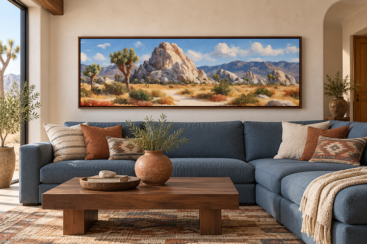 Joshua Tree Forest long horizontal canvas wall art in a walnut frame above a blue sectional sofa.