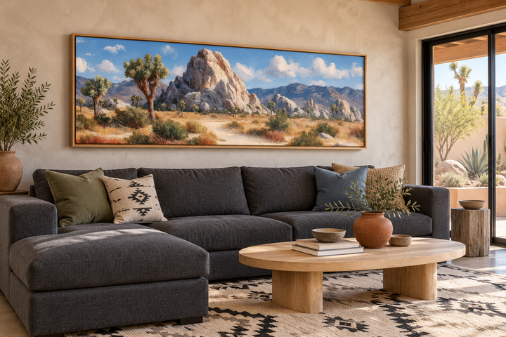 Joshua Tree Forest long horizontal canvas wall art above a charcoal sectional in a desert-style room