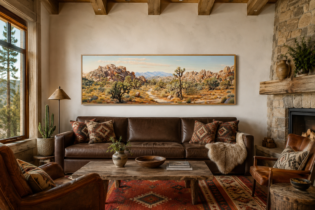 Panoramic Joshua Tree National Park canvas wall art above a brown leather sofa in a rustic room.