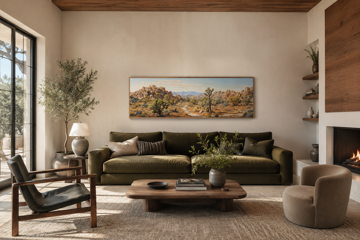 Joshua Tree National Park horizontal canvas wall art above a green sofa in a desert-style room.