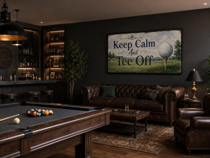 Keep Calm Tee Off vintage golf sign on a dark wall above a leather sofa in a man cave with a bar.