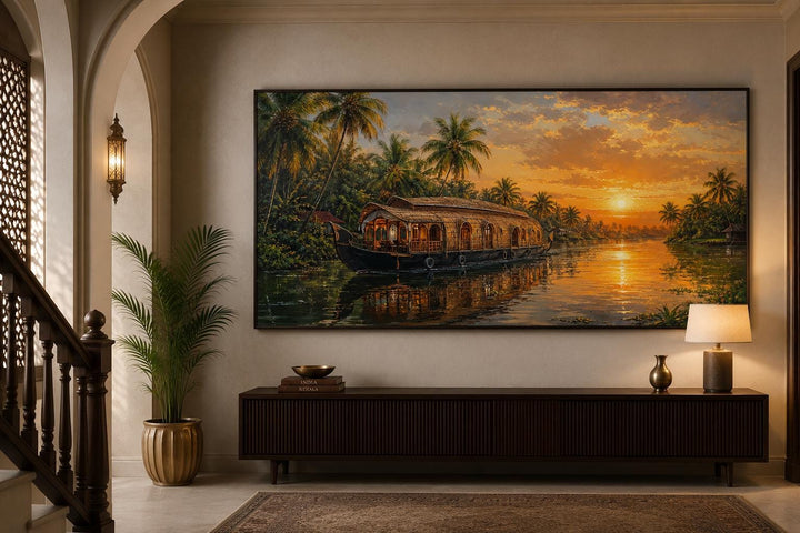 Kerala backwaters houseboat painting at sunset on a living room wall above a dark wood console.