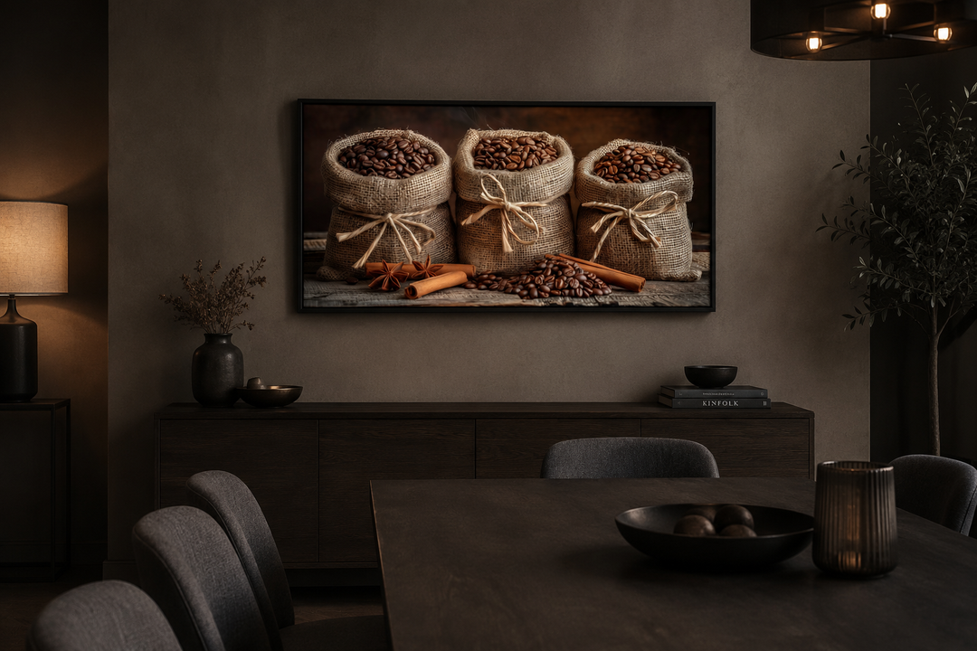 Framed canvas wall art of coffee beans in burlap bags and cinnamon sticks in a dark dining room.