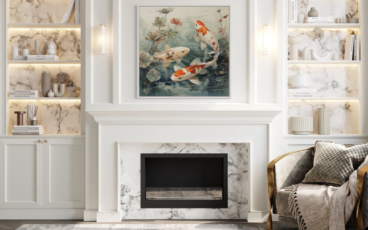 Square framed canvas wall art of koi fish swimming in a sage green pond above a white fireplace.