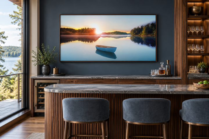 Serene Lake Sunrise With Boat canvas wall art in a walnut frame above a modern home bar.