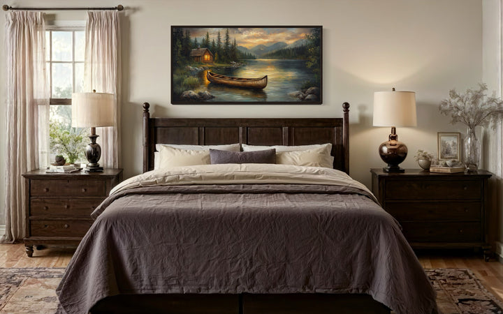 Rustic canvas wall art of a wooden canoe on a serene lake at sunset above a dark wood bed.