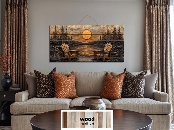 Rustic wood wall art featuring Adirondack chairs by a sunset lake, hanging above a neutral sofa.