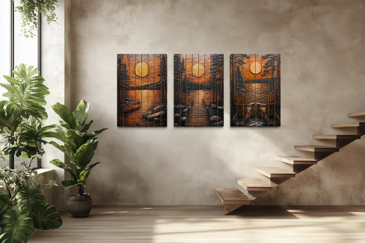 Three-piece rustic wood wall art set featuring a sunset lake scene with a canoe, dock, and chairs.