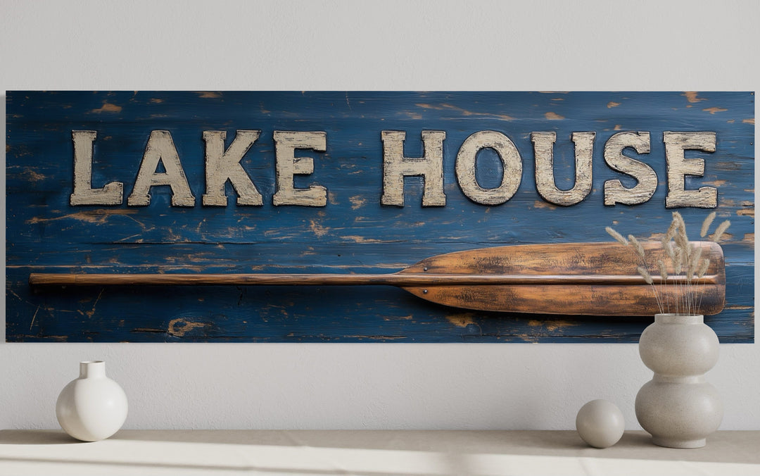 Rustic Lake House sign on distressed blue wood with a wooden oar and white 3D lettering.