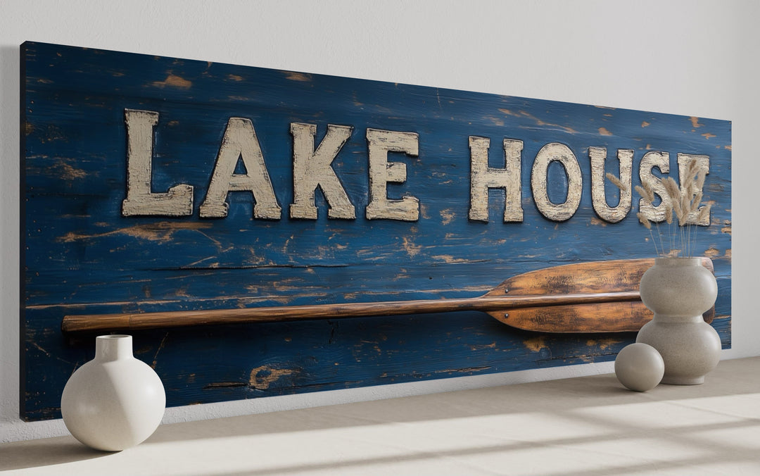 Rustic blue Lake House sign with a wooden oar on a long horizontal framed canvas wall art.