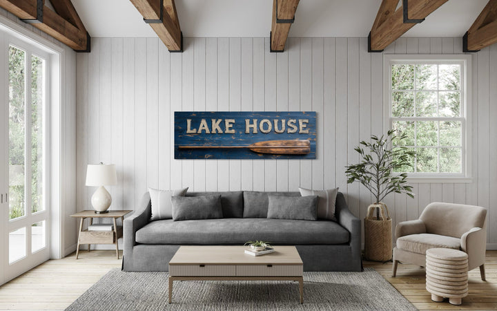 Lake House Sign With Oar Long Horizontal Framed Canvas Wall Art displayed above a gray sofa.