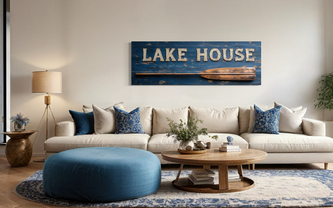 Lake House Sign With Oar framed canvas wall art above a sofa in a rustic living room.