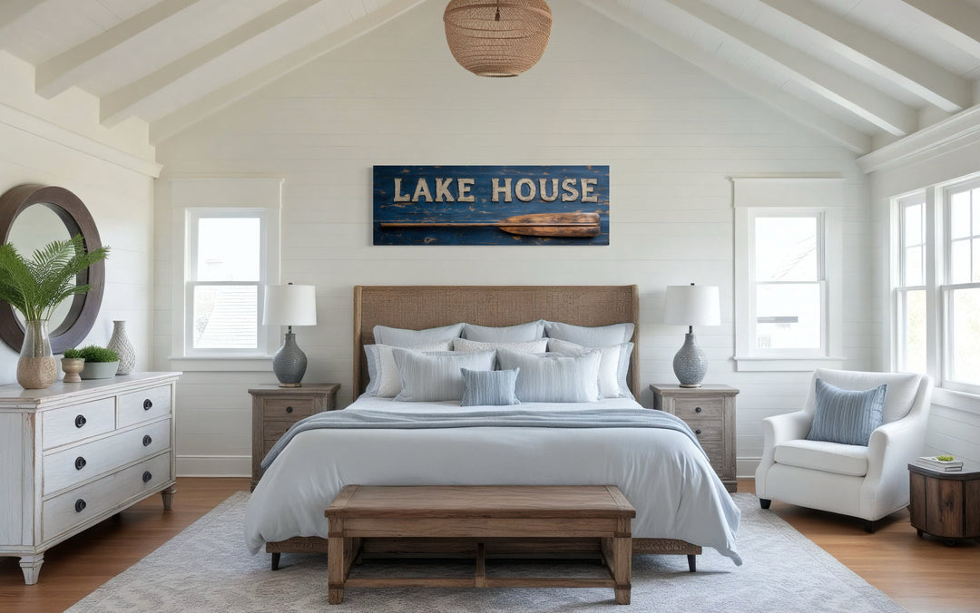 Lake House Sign With Oar Long Horizontal Framed Canvas Wall Art displayed above a bed.