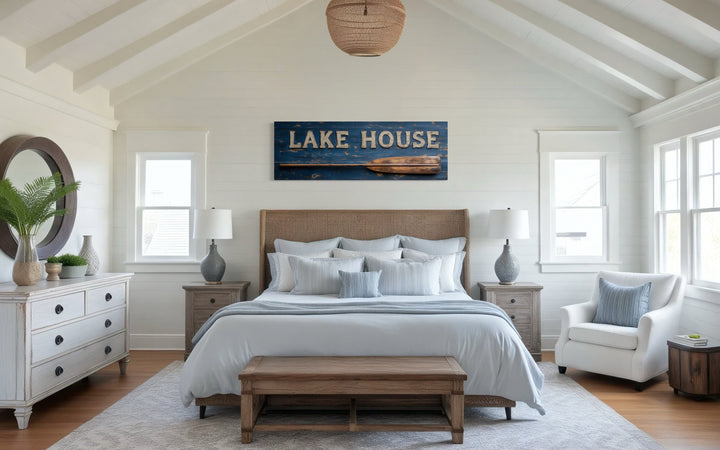Lake House Sign With Oar Long Horizontal Framed Canvas Wall Art displayed above a bed.