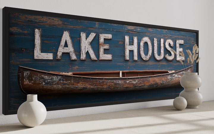 Long horizontal framed canvas art featuring a rustic Lake House sign and a vintage wooden canoe.