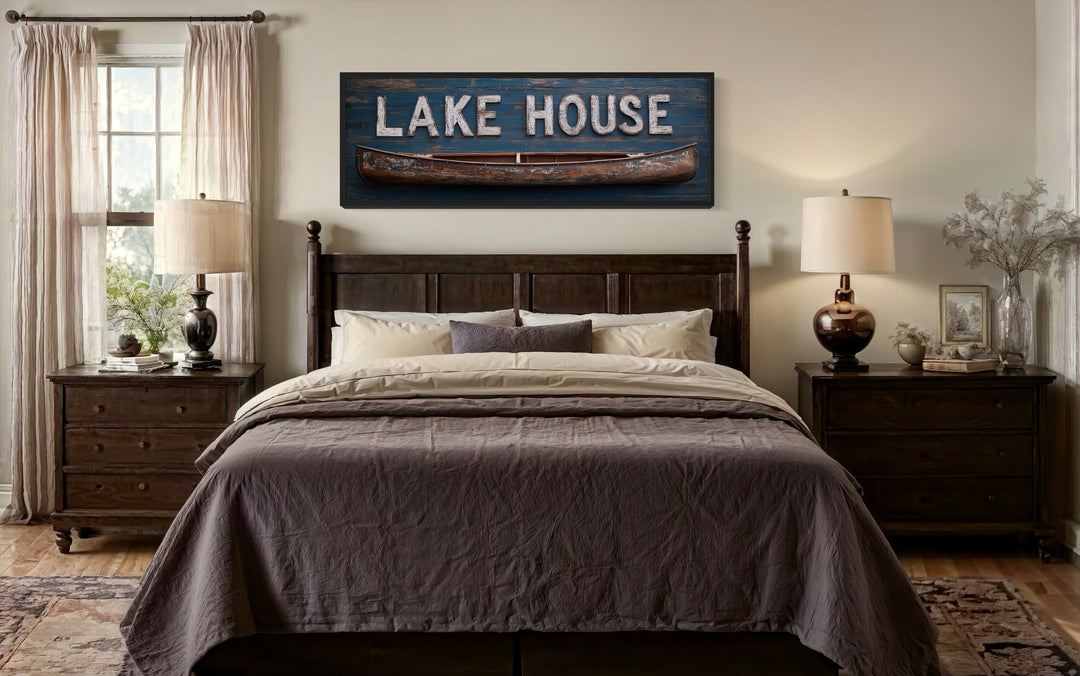 Lake House Sign With Wooden Canoe Long Horizontal Framed Canvas Wall Art above a bed.