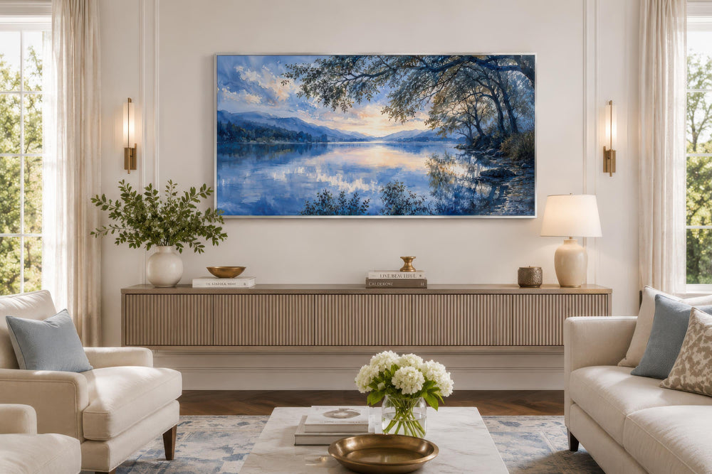 Blue Lake House wall art painting in a silver frame mounted above a modern fluted sideboard.