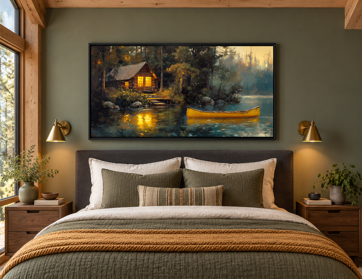 Framed lake house canvas print with a yellow canoe on a lake, hanging above a bed in a rustic room.