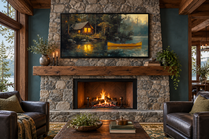 Framed rustic lake house canvas print with a yellow canoe above a stone fireplace in a cozy lounge.
