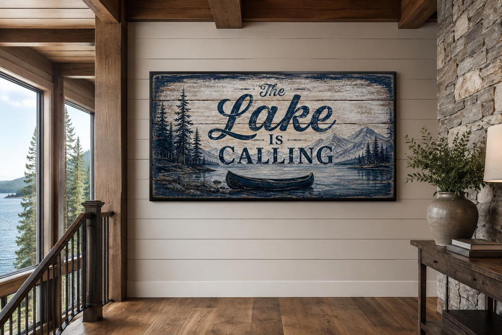 Rustic lake house wall art with 'The Lake Is Calling' text and canoe on a wood-look canvas print.