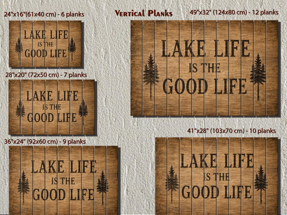 Five sizes of Lake Life Is The Good Life wood wall decor signs with vertical planks and pine trees.