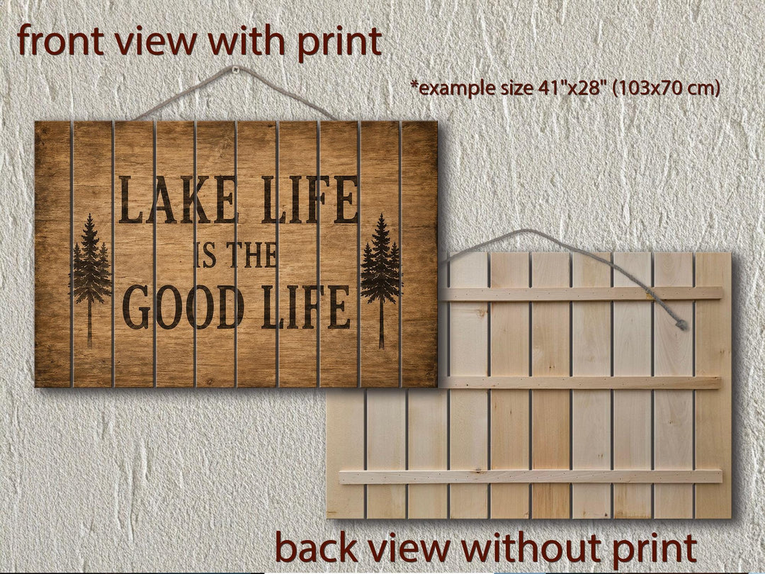 Front and back view of a rustic wood sign reading Lake Life Is The Good Life with pine tree icons.