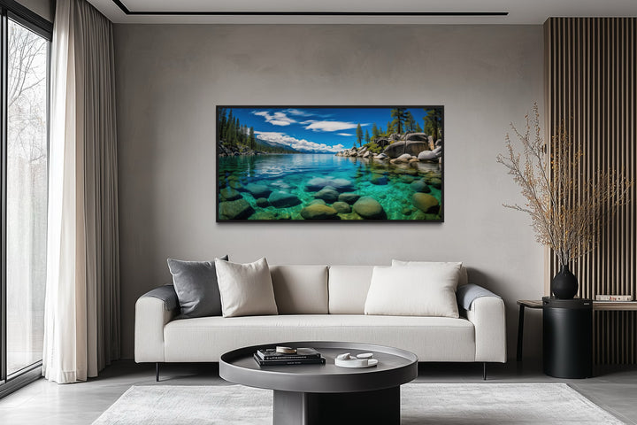 Framed canvas print of Lake Tahoe's Sand Harbor landscape hanging above a sofa in a modern room.