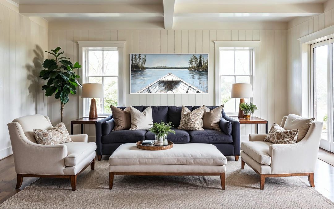 Lake View wall art featuring a white canoe on a blue lake, hung above a sofa in a living room.