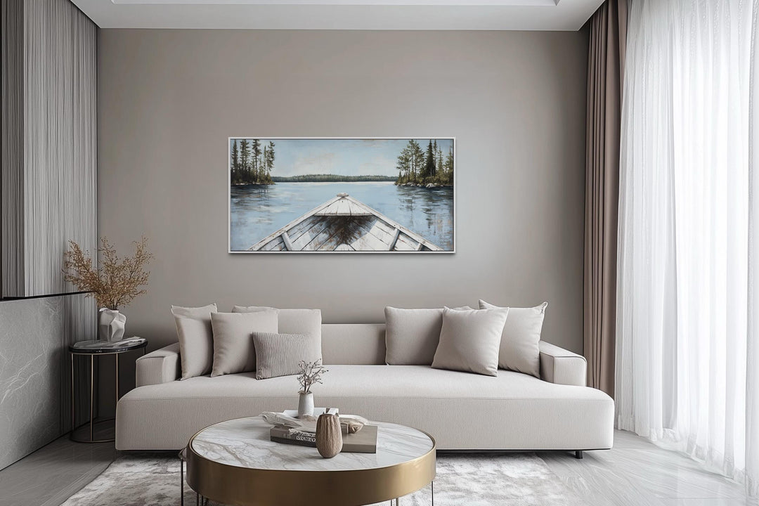 Lake View Wall Art featuring a white canoe on a blue landscape canvas in a modern living room.