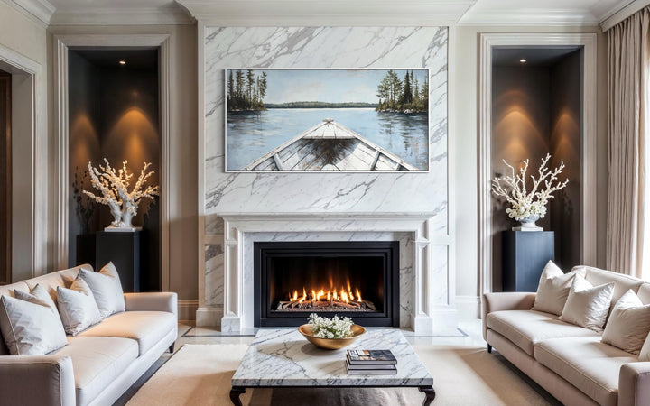 Lake View wall art with a white canoe on a blue lake, displayed above a marble fireplace mantel.