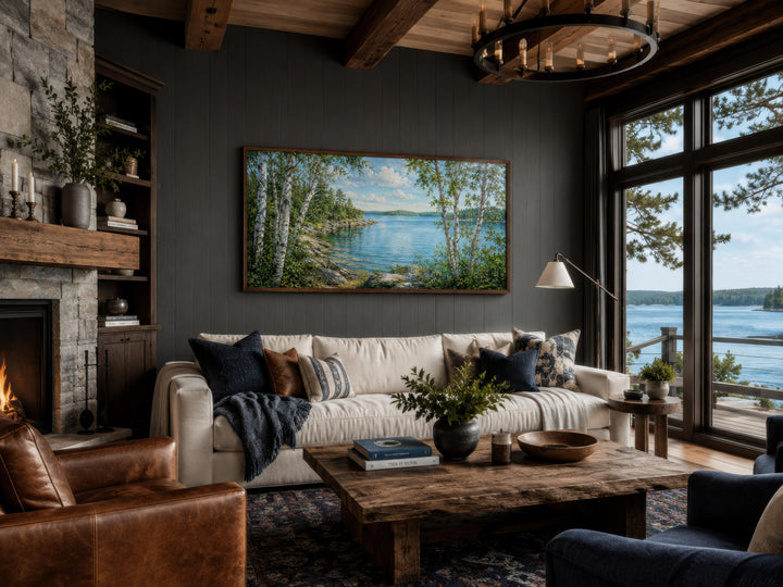 Lake Birch Tree canvas print hanging above a white sofa in a rustic lake house living room.